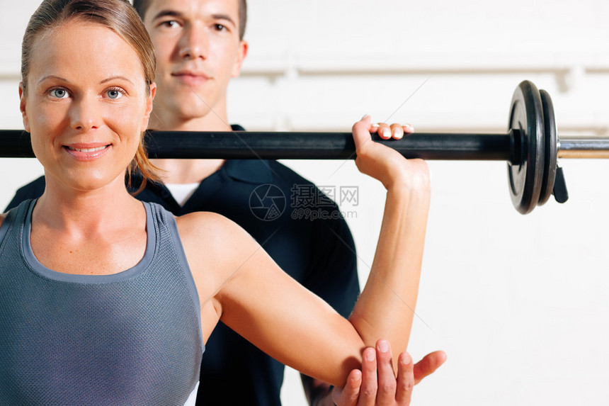 健身房的健身教练用杠铃图片