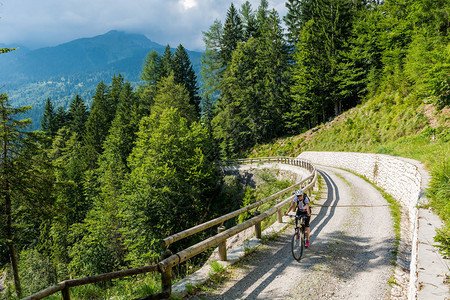 有吸引力的女骑自行车者解决陡峭的道路享受麦当娜迪坎皮图片