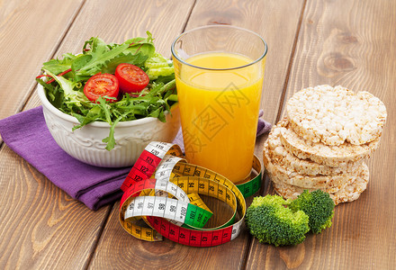 健康食品和木桌上的卷尺健身和健康图片