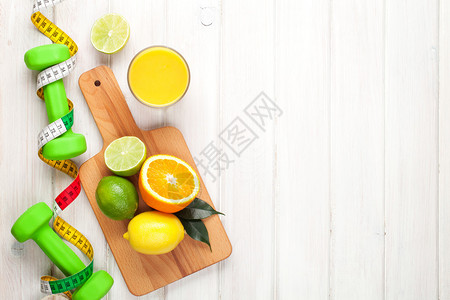 柑橘水果胶土和哑铃橙子石灰和柠檬健康食品木板背图片