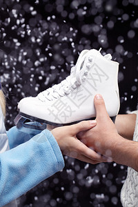 拿着图白色溜冰鞋的手特写镜头背景图片