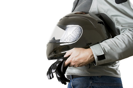 戴头盔和手套的防护装备中的摩托车手的托索图片