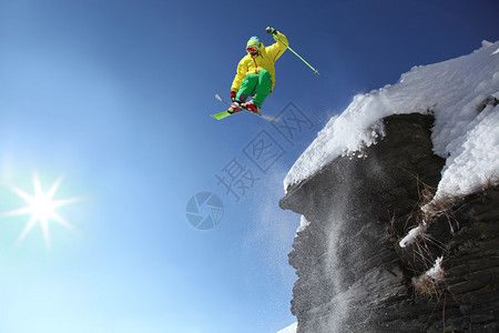 滑雪者从高山的悬崖上跳下空中高清图片