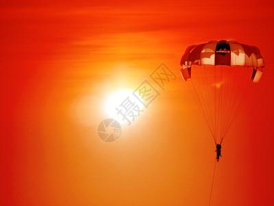 一个美丽的背景旁观降落伞在背景日落图片