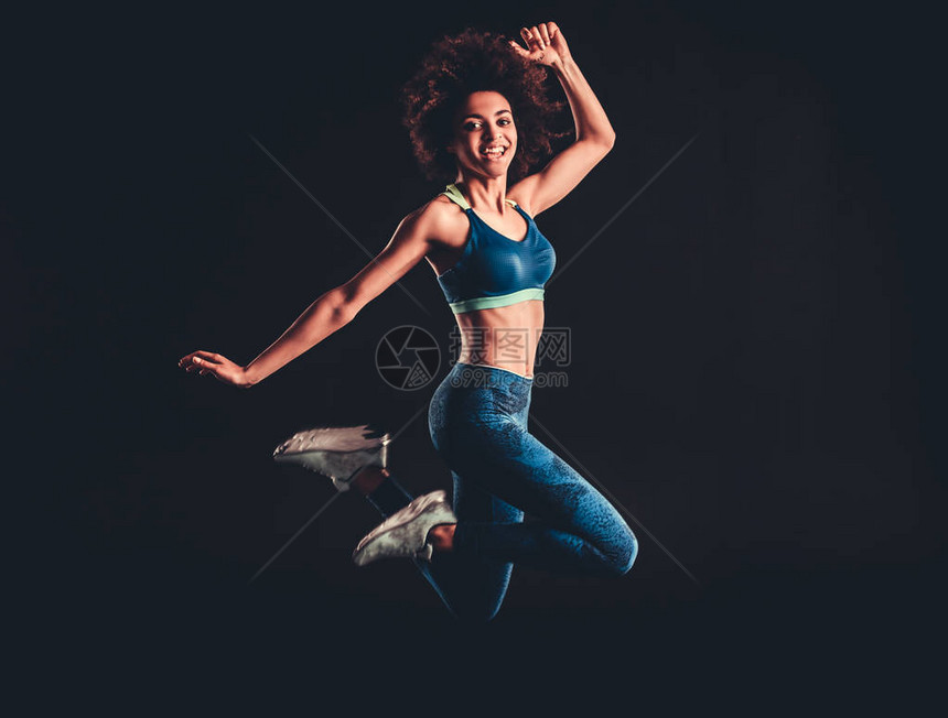 穿着运动服的有吸引力的非裔美国女孩正在跳跃图片