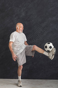 快乐的老人在室内踢足球图片
