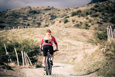 山地自行车骑自行车在夏天山风景男子在乡村公路上骑山地车运动健身图片