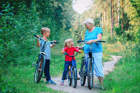 快乐的祖母与孩子男孩和女孩骑自图片