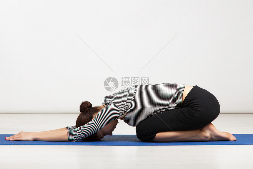 在健身房锻炼瑜伽的年轻女子图片