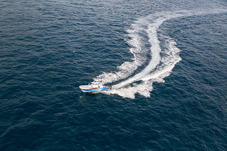 在海洋中飞溅和唤醒的快速摩托艇图片