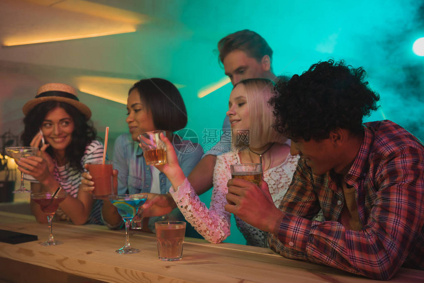 多民族朋友团体在酒吧柜台共饮图片