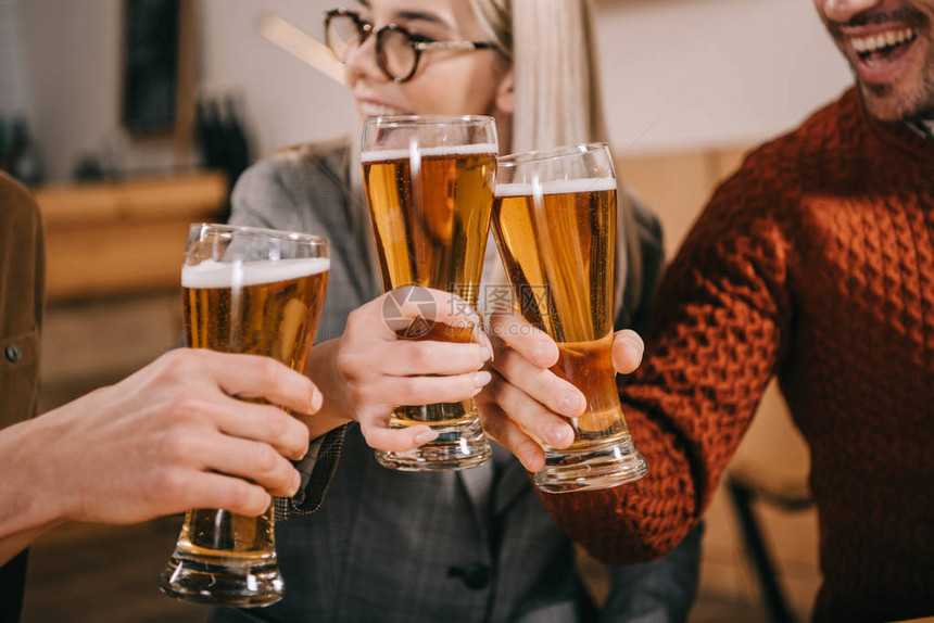 快乐的女人和朋友喝啤酒的剪影图片