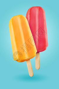蓝色背景上的黄色和紫色冰棒淇淋棒背景图片