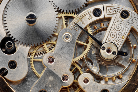 准确度老式时钟机械的齿轮特写背景