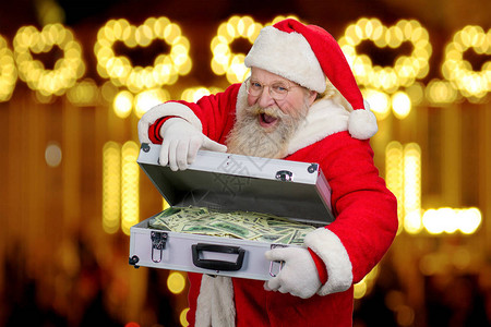 快乐的高级圣诞老人正在用美元钞票打开银外交官图片