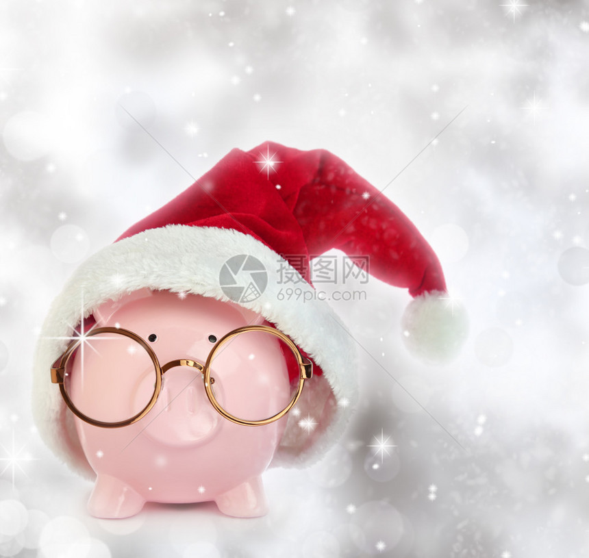 长着圣诞老人帽子和眼镜的猪银行面图片