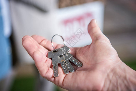 销售商持有新房钥匙出售房屋背景图片