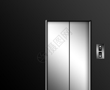 灰色墙上的镀铬电梯门带有上下按钮图片