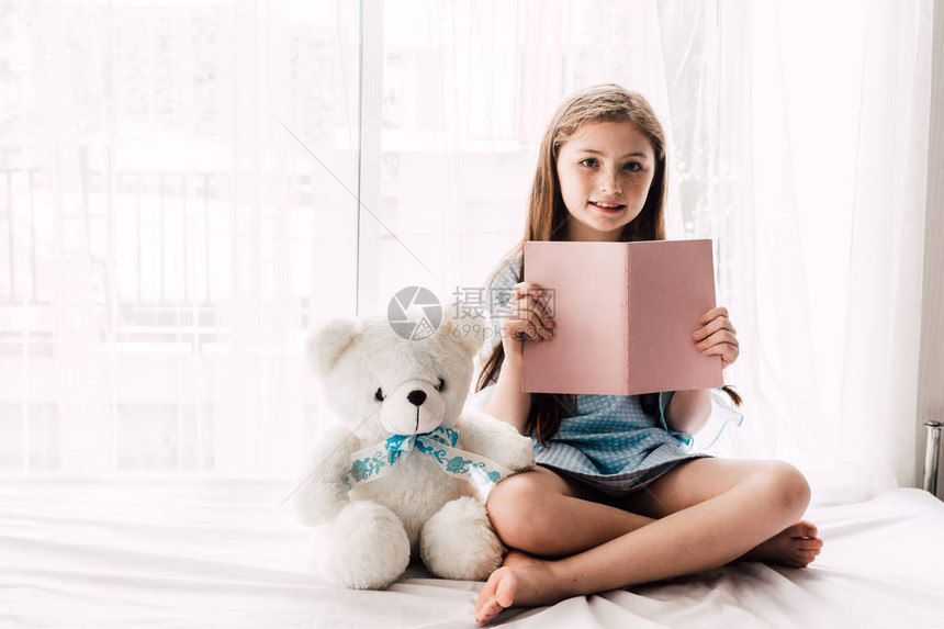 可爱的小女孩正在看一本书图片
