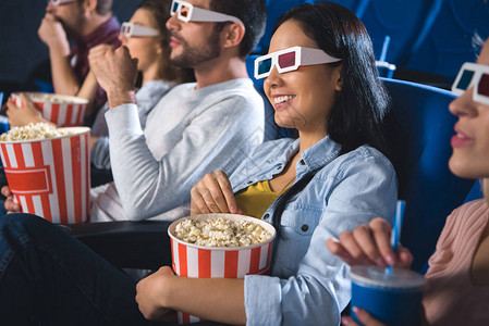 带着爆米花一起在电影院看电影的3d眼镜中微笑图片