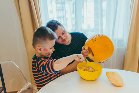 年幼父亲和小孩的儿子在万圣节上图片