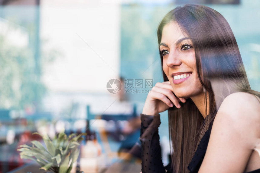 坐在餐厅里的快乐年轻女人图片
