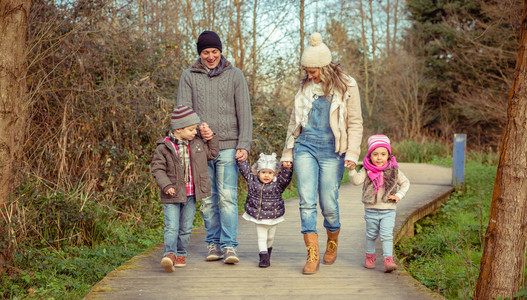 幸福的一家人一起走在一起手握着木制通图片
