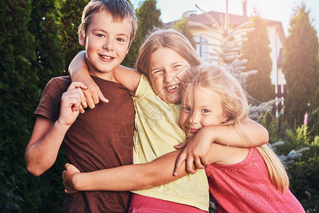 快乐的小朋友在院子里玩得开心的肖像三个可爱的小朋图片