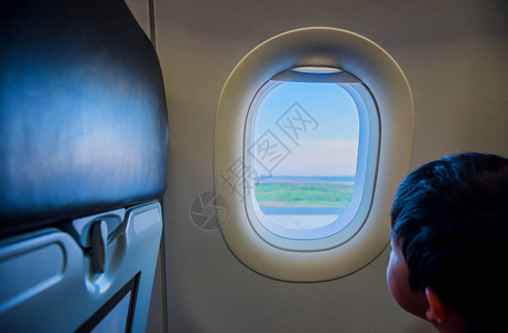 儿童在飞机上观看窗口的图像图片