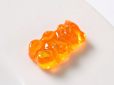单颗橙色小熊软糖背景图片