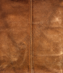 带有中心缝的旧棕色旧皮革背景图片