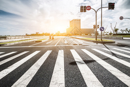 带斑马交叉和方向板的空道路在阳图片