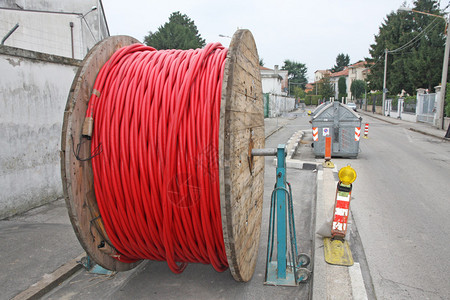 在户外和地下铺设期间公路上有线和光纤的背景图片