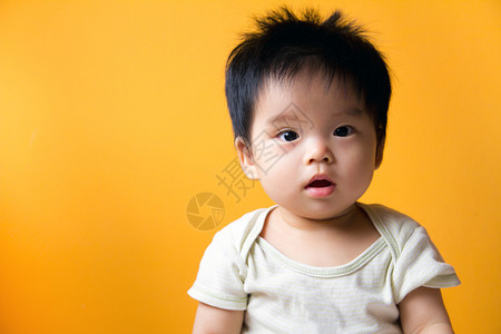 黄色背景的亚洲小女孩的肖像图片