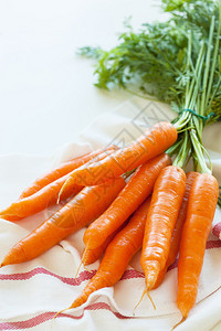 毛巾上的生胡萝卜蔬菜图片