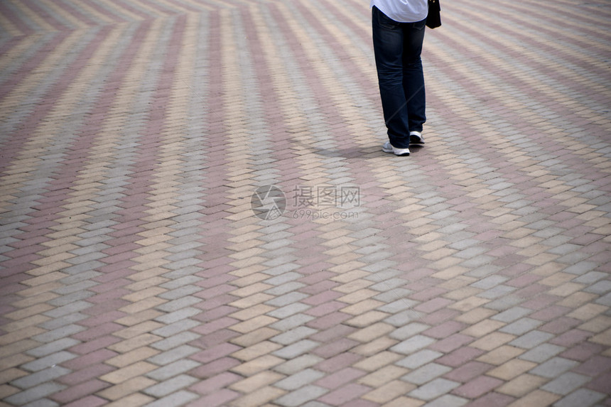 一个人的腿在行人路上行走时用瓷砖相图片