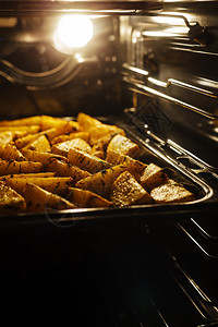 在家里的烤箱里煮热土豆背景图片