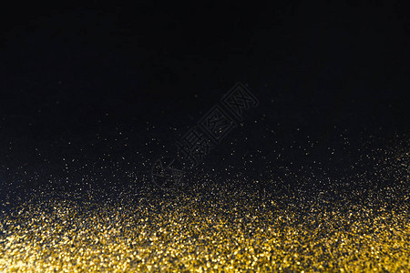 金色闪光砂纹理边框黑色抽象背景与复制空间图片