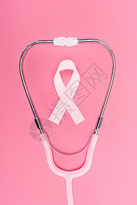 粉红背景的听诊器上的粉色乳腺癌标志图片