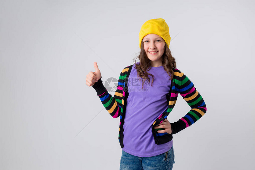 穿着黄色帽子多色毛衣和紫色T恤的少女图片