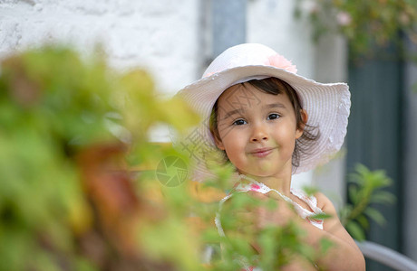穿着白帽子的可爱小女孩在温暖阳图片