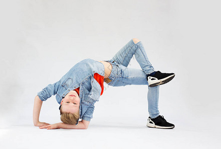 一个年轻男孩在一个独特的破碎舞姿势图片