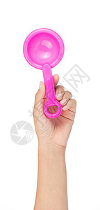 手握着玩具塑料粉红色的铲子在白色图片