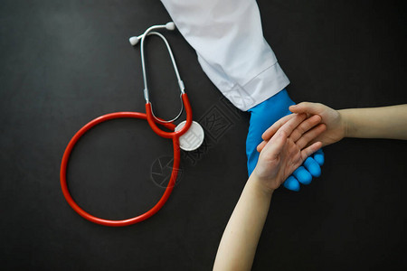 医学概念戴手套的医生握着病人的手医生对病人的道德帮助心脏病专家图片