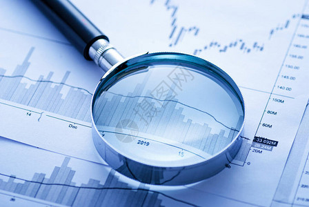 商业图表上的放大镜和笔在会计研究或审计的概念中显示波动的业绩图片
