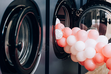 在露天洗衣房中靠近现代洗衣机的粉红色气图片