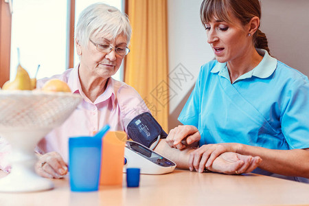 护士测量老年妇女的血压图片