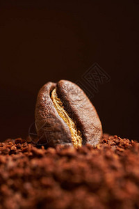 磨碎的咖啡和棕色背景上的咖啡豆特写图片