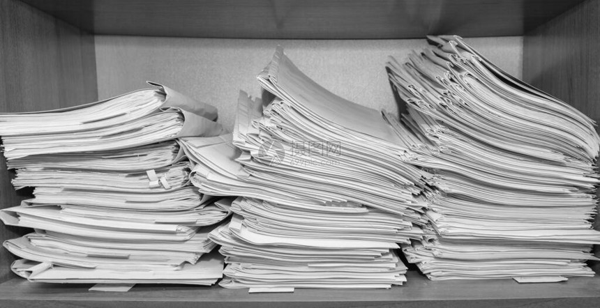 堆积在档案中的纸质文件档案室货架上的文件衣柜里的办公室架子上堆满了文图片