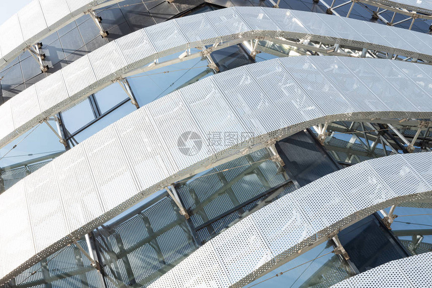 带圆孔和窗户的金属穿孔板的高现代建筑结构的对角线视图现图片